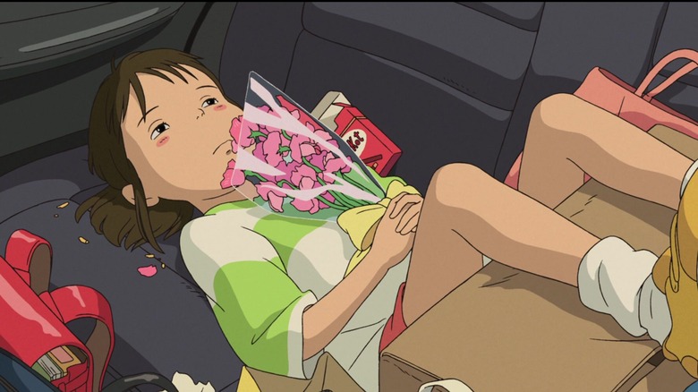 Chihiro lying sullenly in backseat