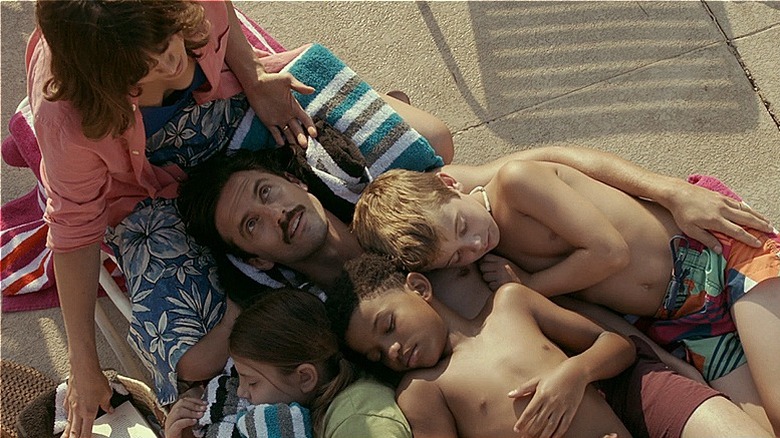 The Pearsons snuggling on a pool lounger 