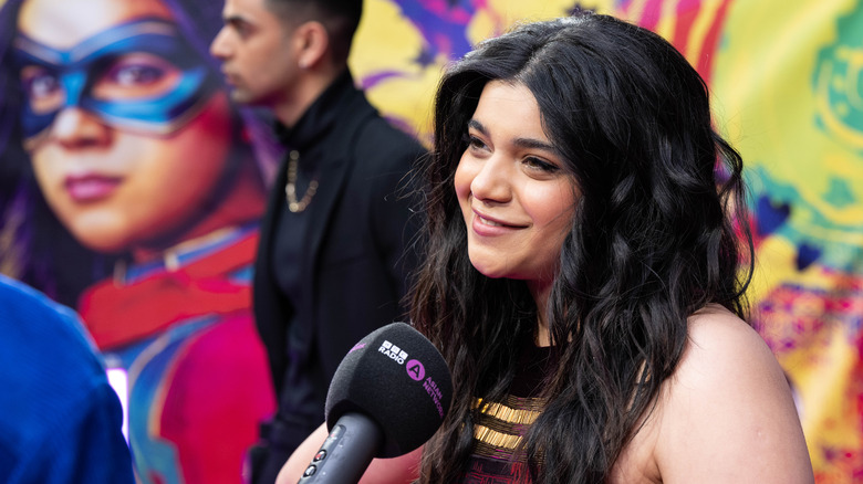 Iman Vellani smiling into microphone