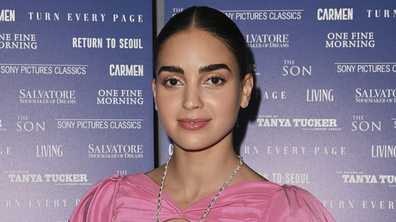 Melissa Barrera smiling in pink with necklace 