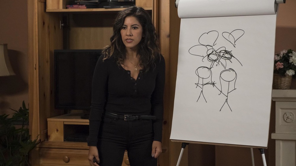 Rosa plays pictionary during family game night. 