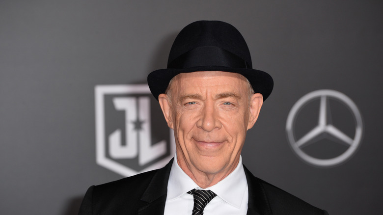 J.K. Simmons smiling with fedora