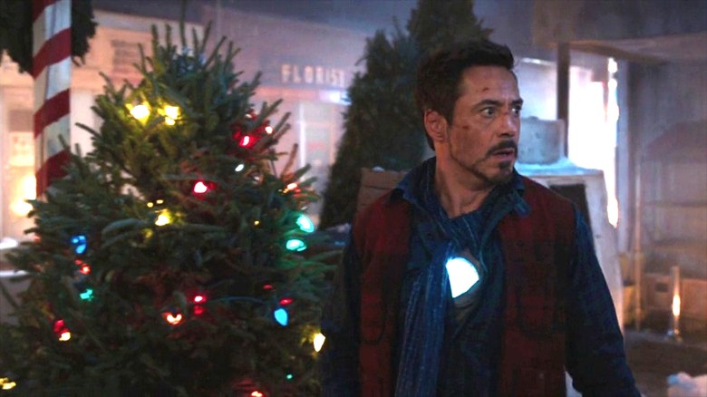 Robert Downey Jr. as Tony Stark, walking by a Christmas tree in Iron Man 3 (2013)