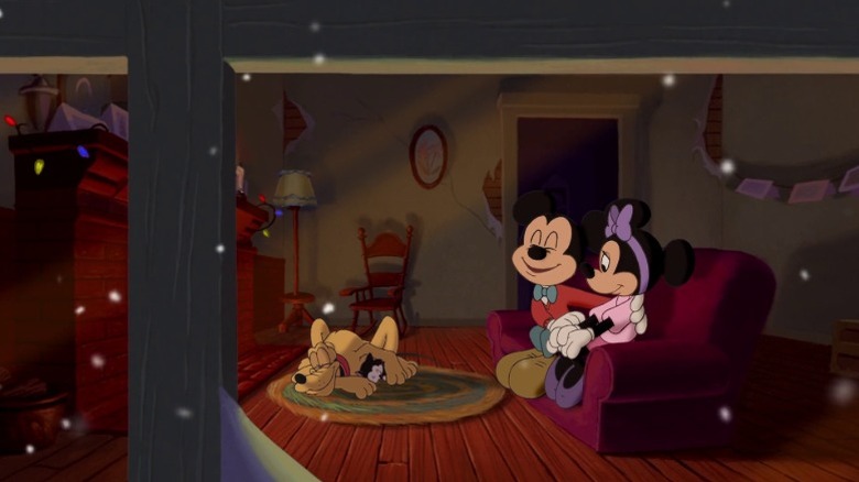 Mickey and Minnie Mouse sitting together on the couch on Christmas night while Pluto and Figaro sleep on the carpet in Mickey's Once Upon a Christmas (1999)