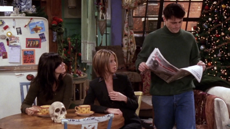 Joey walking with newspaper on Friends