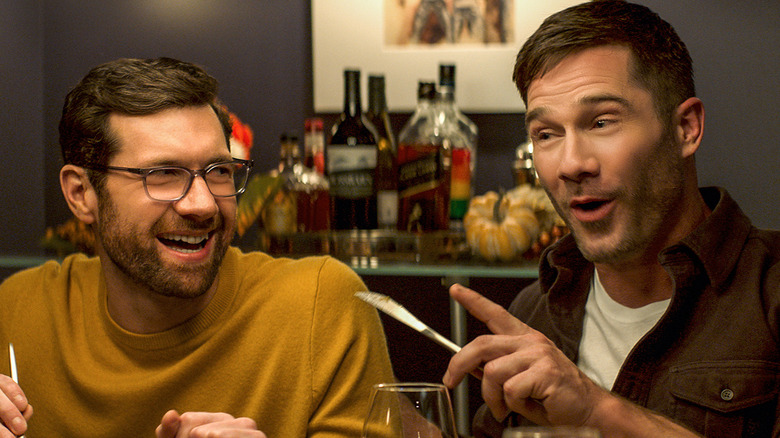 Billy Eichner and Luke MacFarlane laughing at dinner