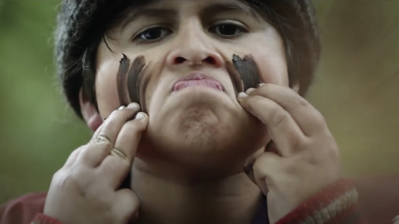 Julian Dennison smears mud 