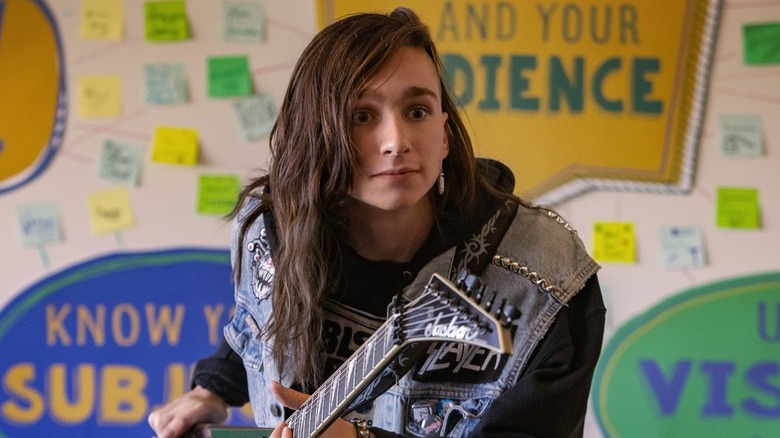 Brunette kid holding guitar