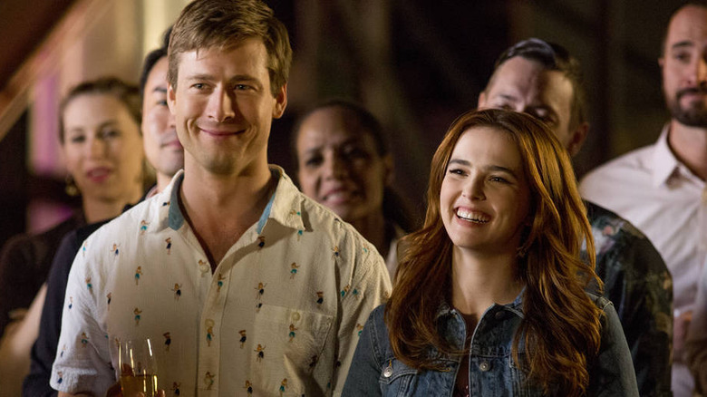 Zoey Deutch and Glen Powell smile