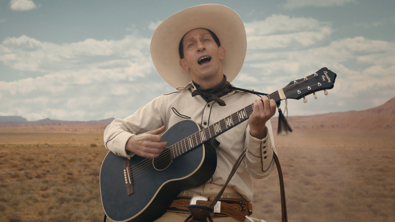 Buster Scruggs playing guitar