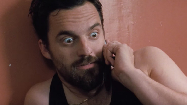 Jake Johnson wide eyed on phone