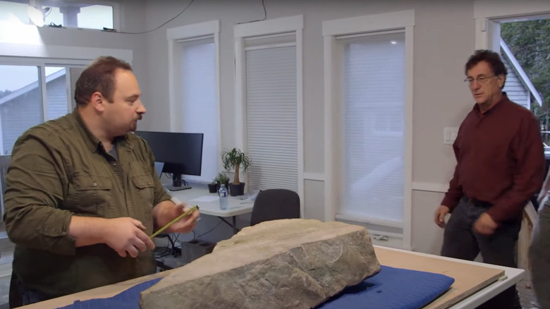 Marty Lagina inspects an etched stone