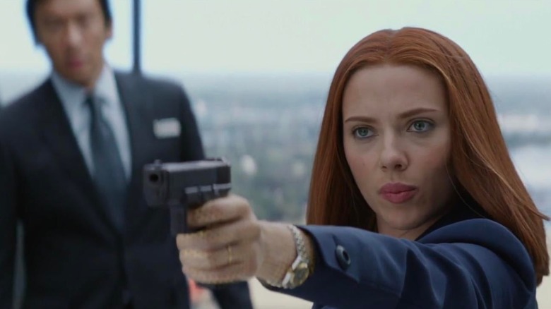 Natasha pointing a gun