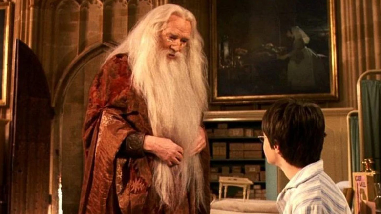 Dumbledore speaks to seated Harry Potter