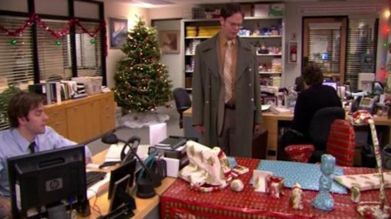 Dwight looking at gift-wrapped desk