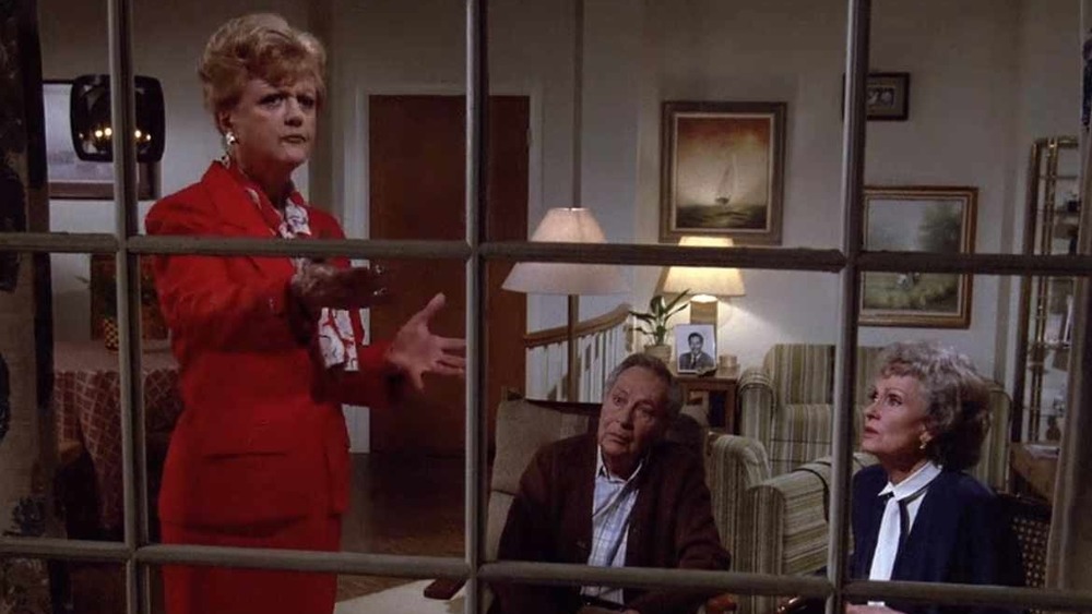 Jessica Fletcher stands at a window in Murder, She Wrote