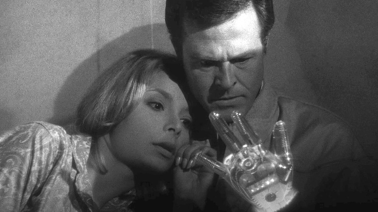 Trent and Consuelo examine his glass hand