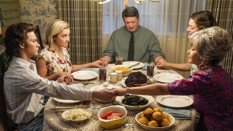 The Cooper family praying over dinner