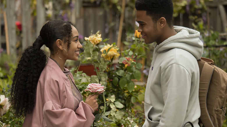 Chosen Jacobs and Lexi Underwood talking in a garden