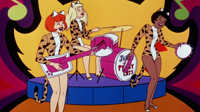 Josie and the Pussycats play on stage