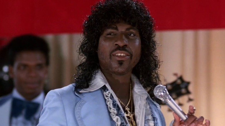 Randy Watson holds a microphone in "Coming to America" (1988)