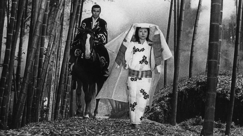 Woman and samurai walking in woods