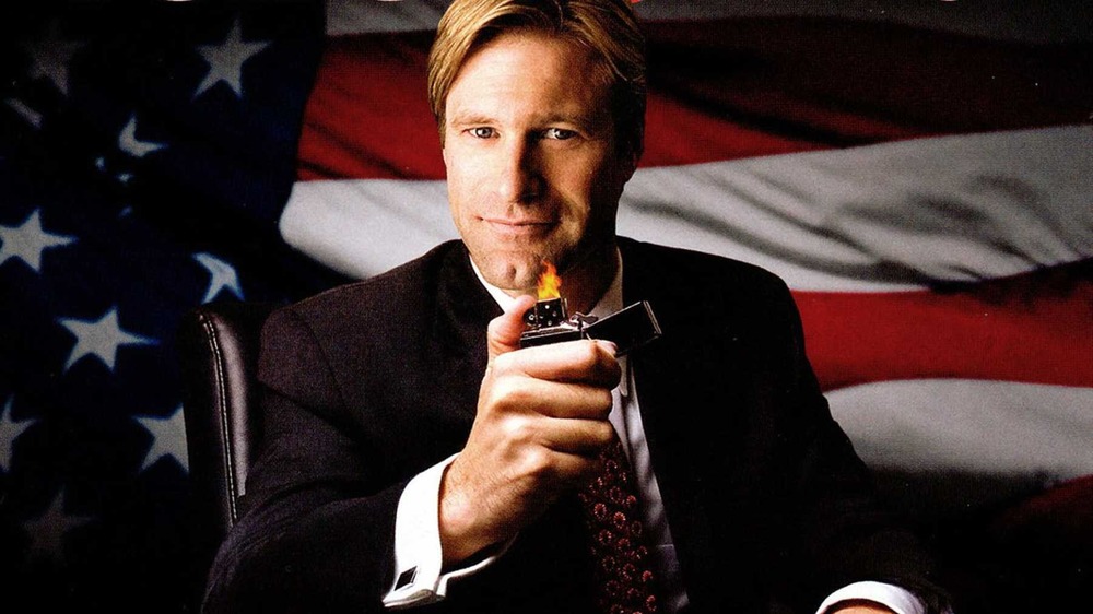 Aaron Eckhart holding zippo in front of flag