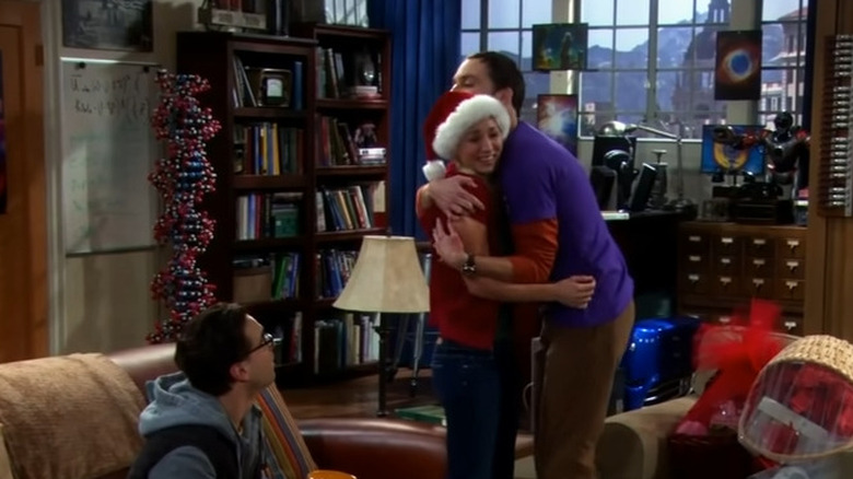 Jim Parsons giving Kaley Cuoco an awkward hug