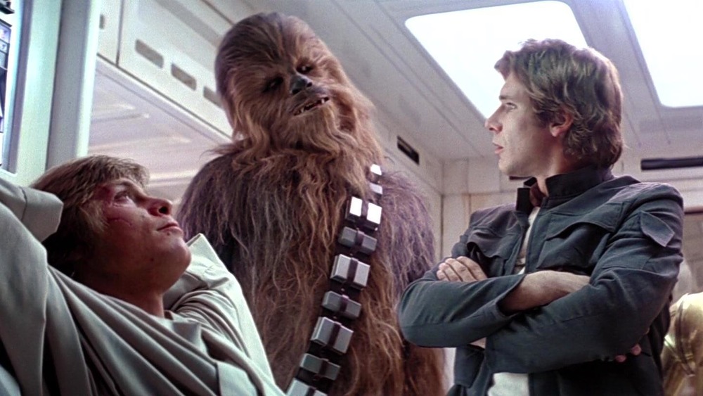 Chewie laughs at Han while Luke gloats