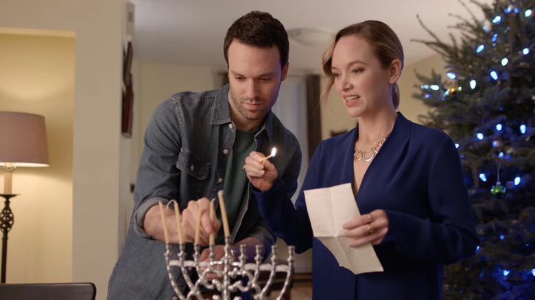 couple lighting menorah