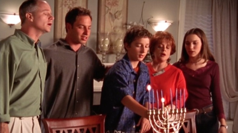 Even Stevens family lighting menorah