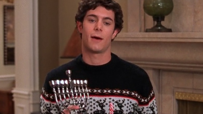 Seth Cohen holding menorah