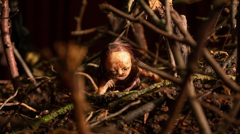 Stop-motion puppet crawls in twigs