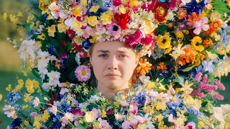 Dani frowns while covered in flowers