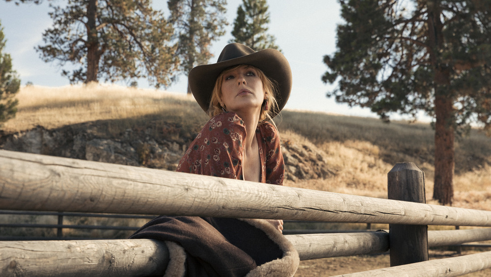 Yellowstone Beth Dutton wearing a cowboy hat and staring into the distance