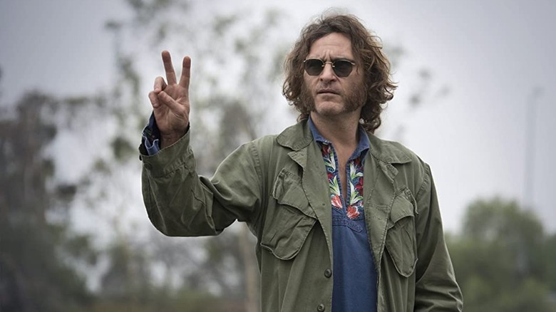 Joaquin Phoenix giving peace sign