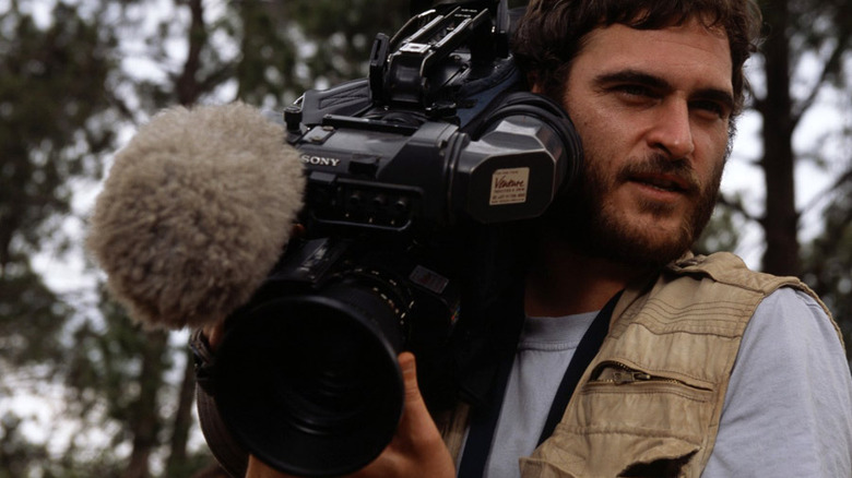 Joaquin Phoenix holding camera