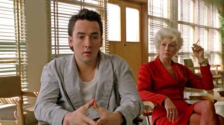 John Cusack sitting with Anjelica Huston