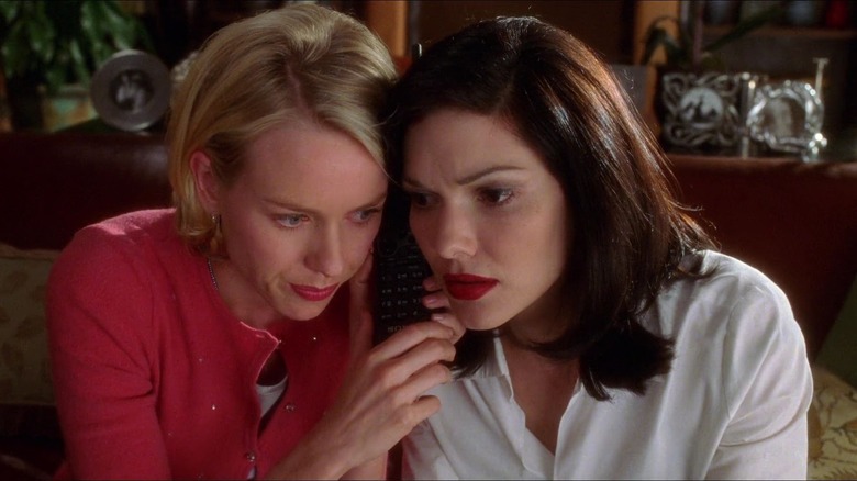 Naomi Watts and Laura Elena Harring listen to phone together