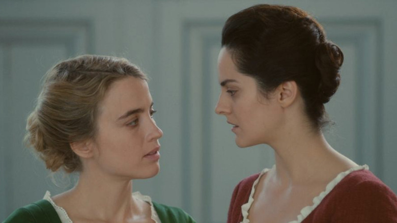 Noémie Merlant and Adèle Haenel look at each other in profile