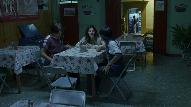 Tenoch, Luisa, and Julio sitting at table in restaurant