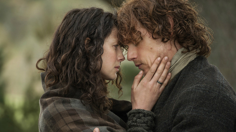 Claire and Jamie embrace each other