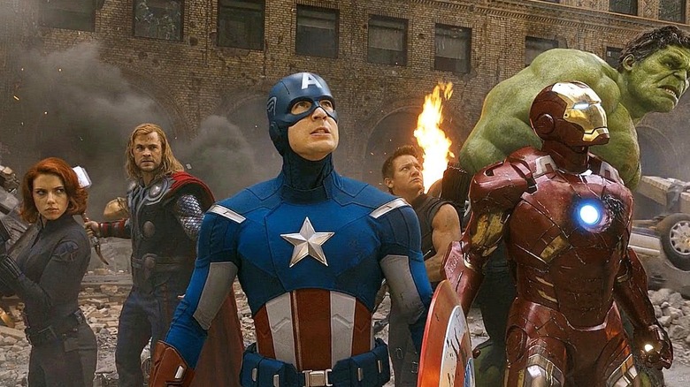 The Avengers are standing in ruins of a city.