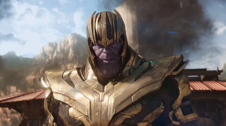 Thanos is wearing armor and a helmet.