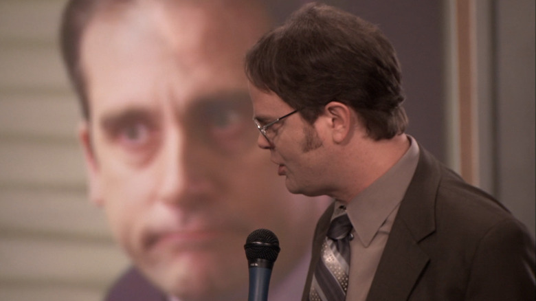 Dwight Schrute talking into microphone