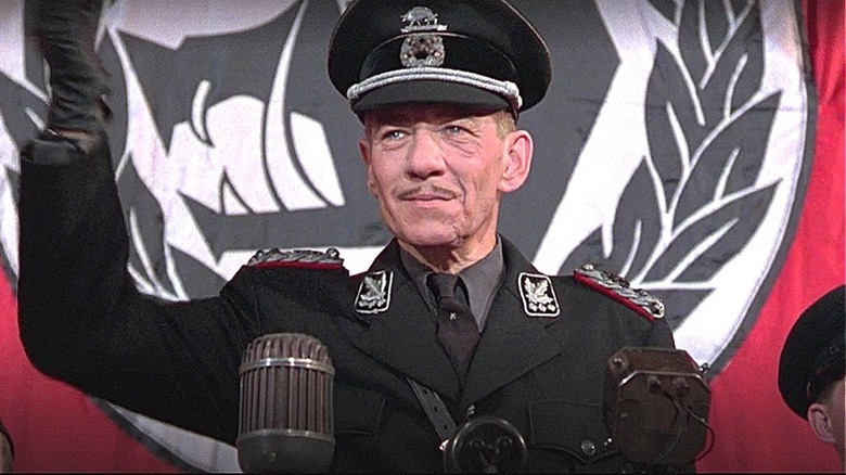 Ian McKellan in black uniform and hat