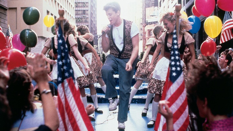 Ferris Bueller sings on a parade float