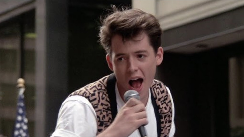 Ferris sings in a parade in Ferris Bueller's Day Off (1986)