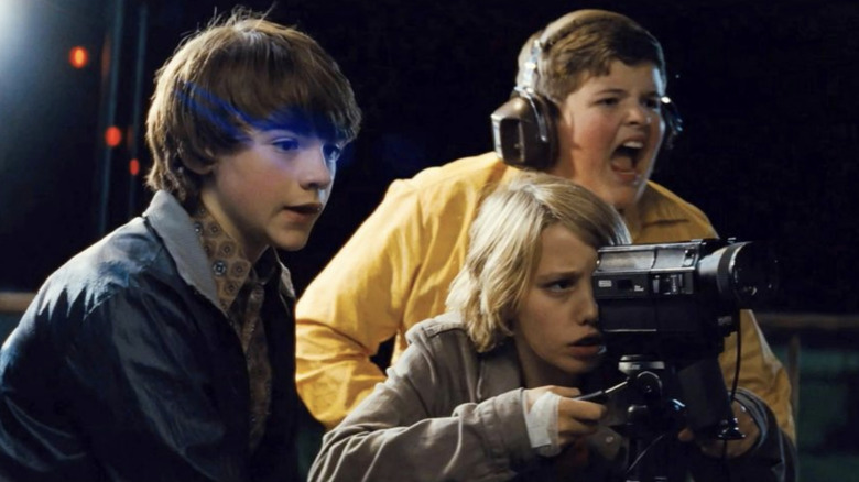 Joe, Charles, and Cary film a scene at the train station at night in Super 8 (2011)