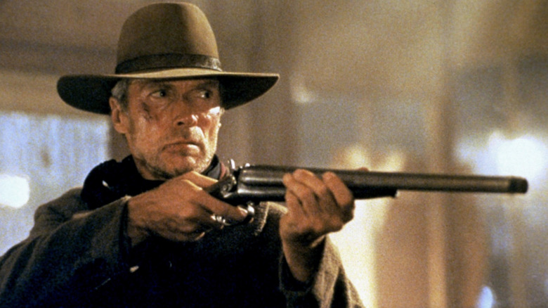 Will Munny raises his rifle against his enemies in Unforgiven (1992)